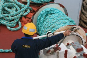 crew member manning the anchor of a ship